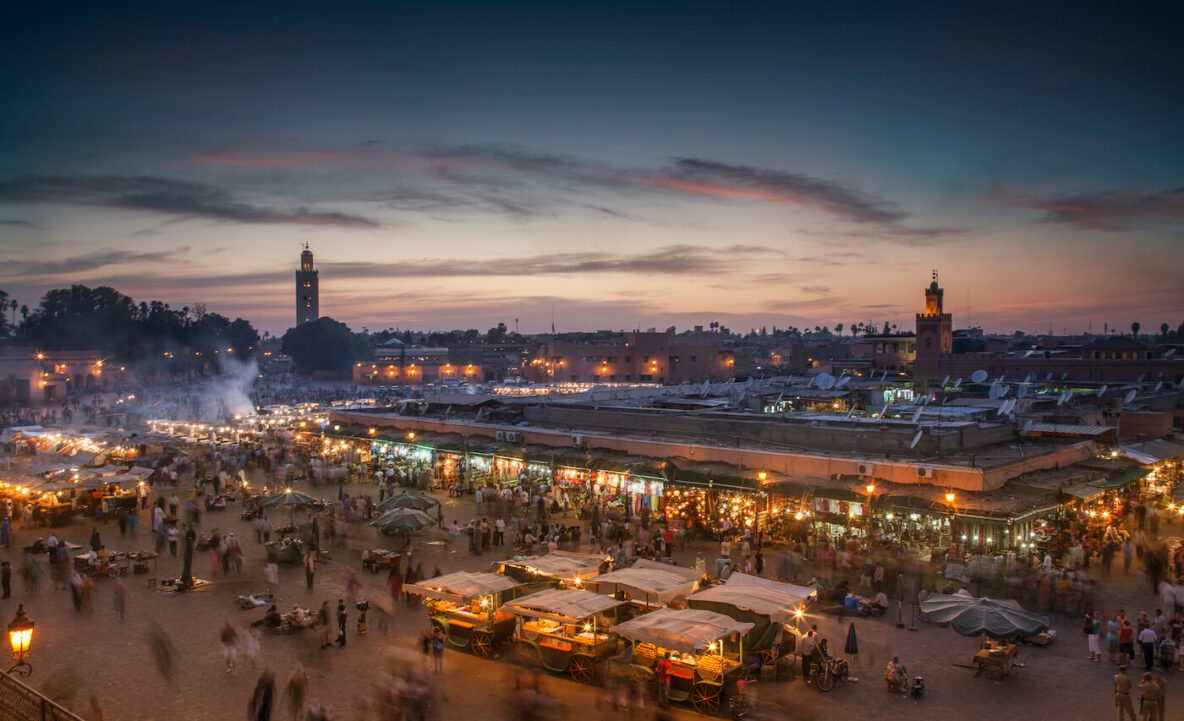 The vendors and market of Jemaa el-Fnaa square in Marrakech, Morocco coming to life at dusk