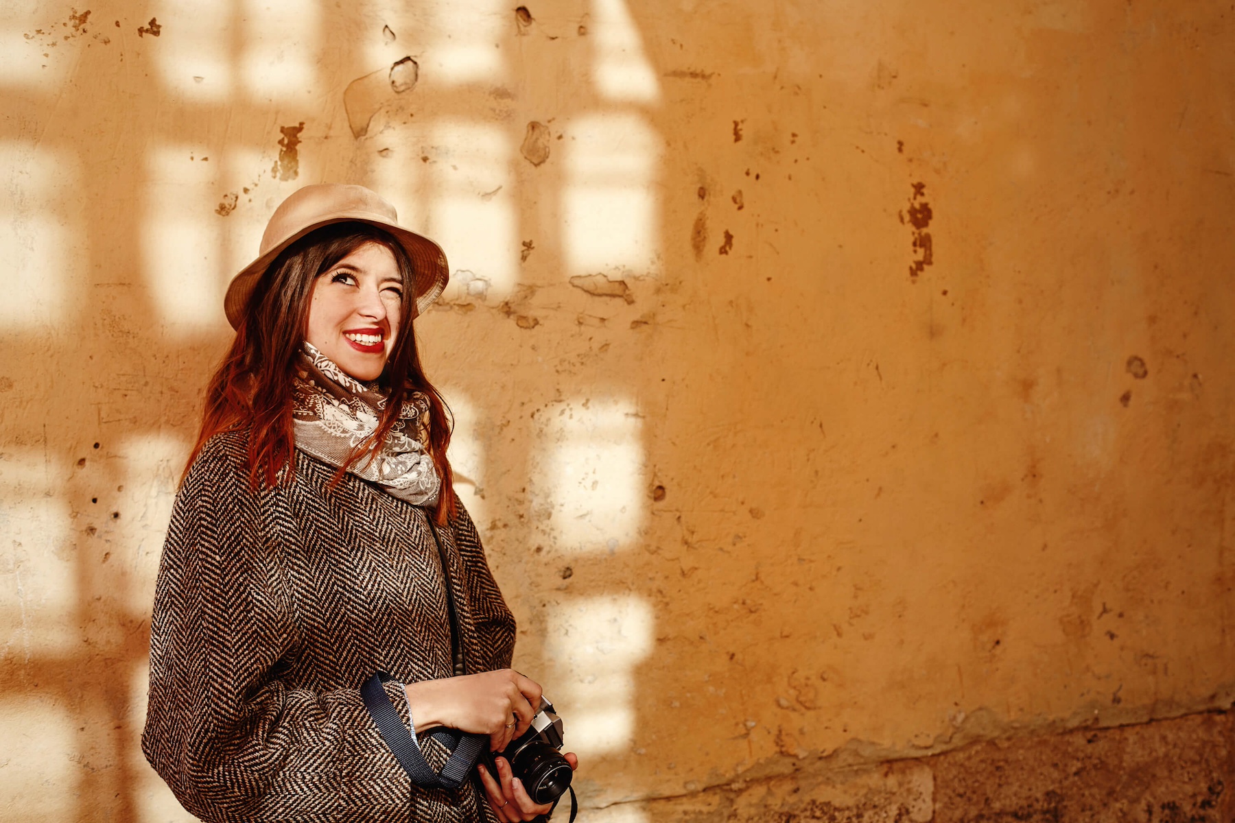 Smiling woman dressed in winter clothes in the Medina of Marrakech Morocco
