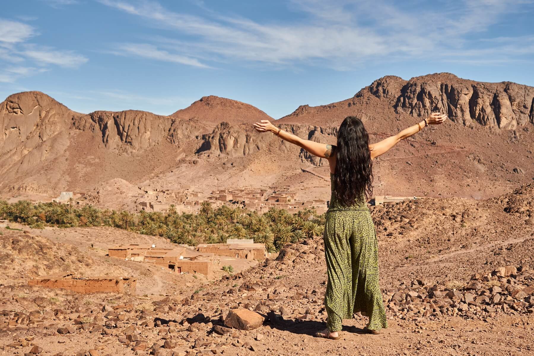 Woman overlooking a Berber village in Morocco in the summer