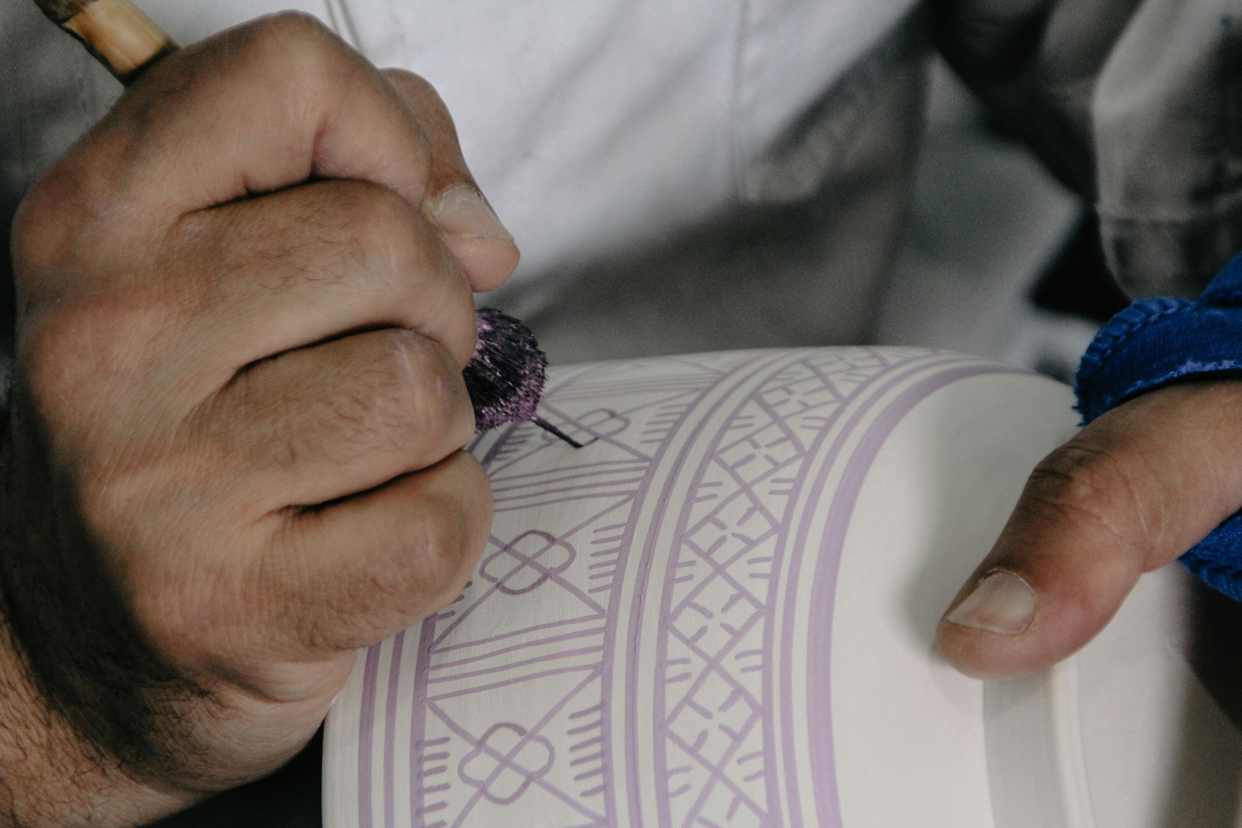 Man painting handmade Moroccan pottery